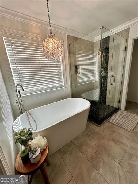 bathroom with ornamental molding, independent shower and bath, and a notable chandelier