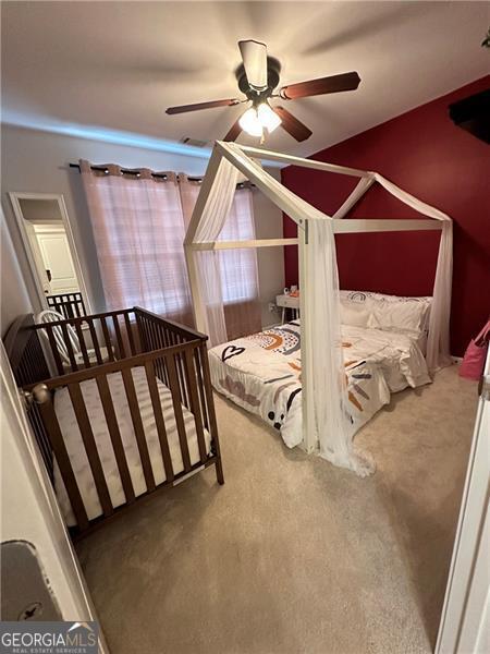 bedroom featuring ceiling fan and carpet flooring