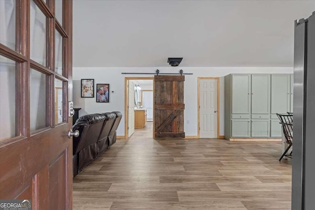 entrance foyer featuring a barn door and light hardwood / wood-style flooring