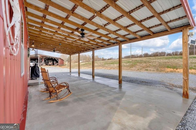 view of patio featuring ceiling fan and a rural view