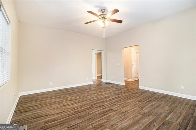 spare room with dark wood-type flooring and ceiling fan