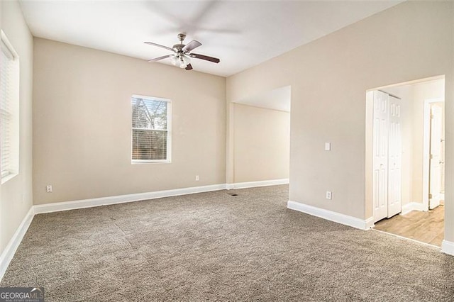 empty room with light carpet and ceiling fan