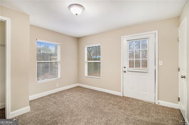 foyer entrance with carpet flooring