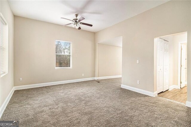 carpeted empty room featuring ceiling fan