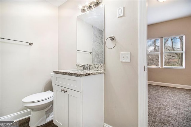 bathroom with vanity and toilet