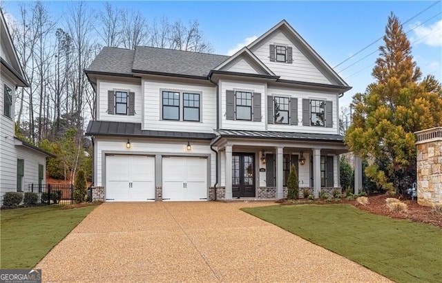 view of front facade featuring a porch, a garage, and a front yard