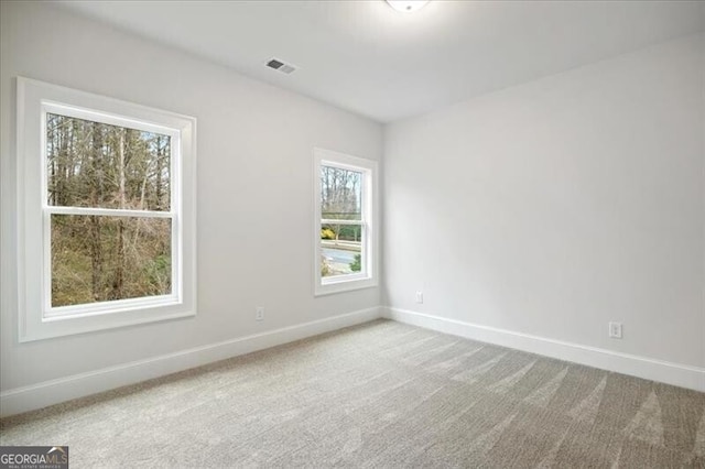 unfurnished room featuring light colored carpet