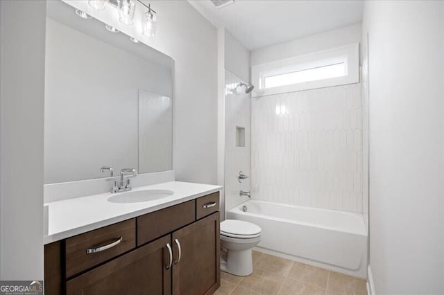 full bathroom with tiled shower / bath, vanity, and toilet