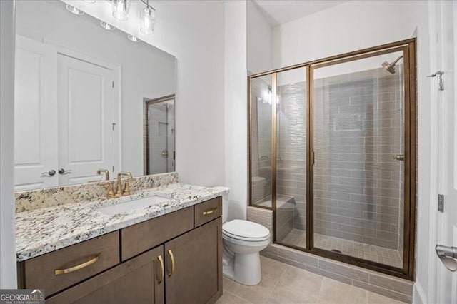 bathroom featuring walk in shower, tile patterned floors, toilet, and vanity