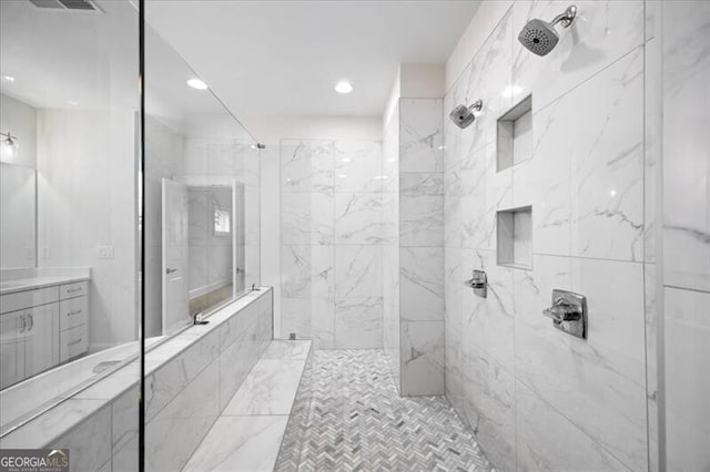 bathroom featuring vanity and a tile shower