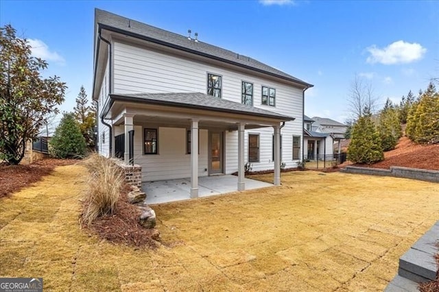 view of front of property with a patio and a front yard