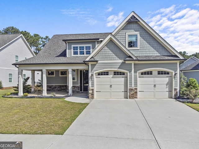 craftsman-style house featuring covered porch and a front lawn