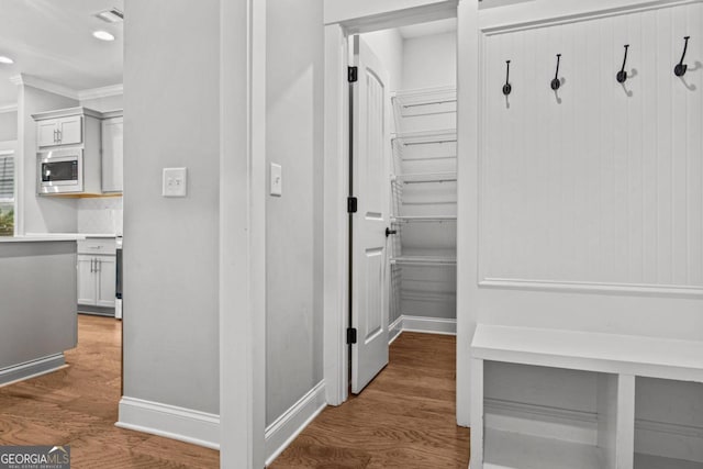 mudroom featuring hardwood / wood-style flooring and crown molding