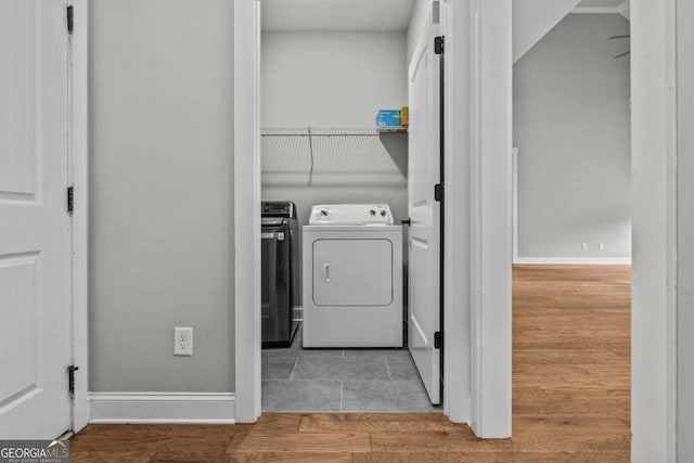 washroom with washer and clothes dryer and wood-type flooring