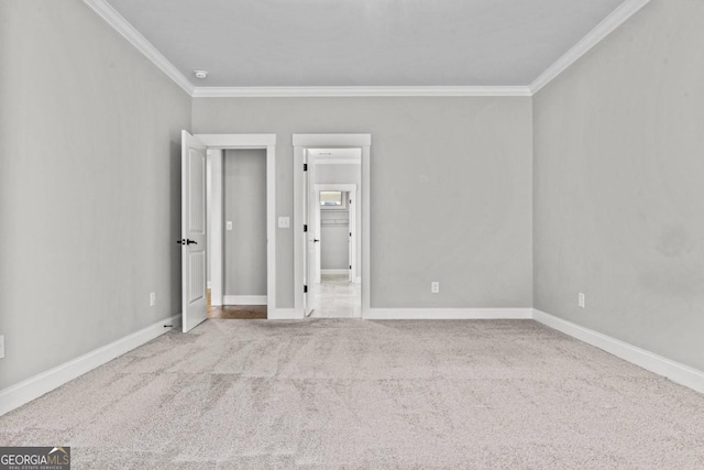 unfurnished bedroom with ornamental molding, carpet floors, and ensuite bathroom