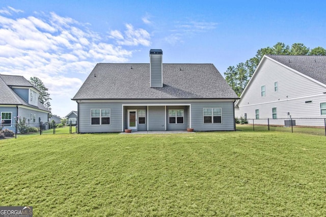 rear view of house with central AC unit, a lawn, and a patio