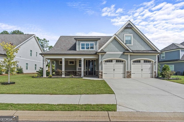 craftsman house with a porch, a garage, and a front yard