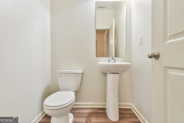 bathroom featuring hardwood / wood-style floors, sink, and toilet