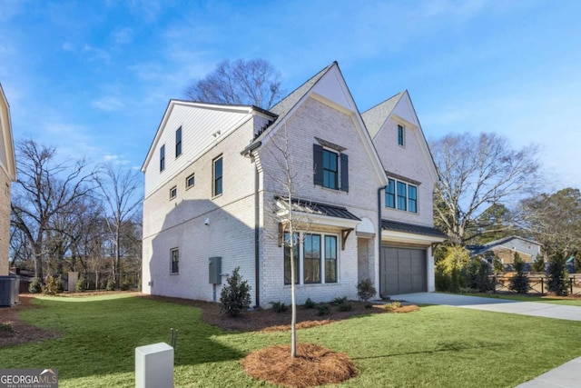 view of front of property featuring a garage, a front lawn, and central air condition unit