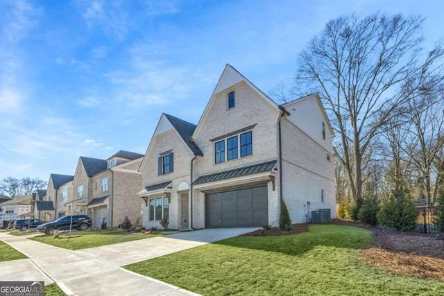 view of front of home featuring a garage, a front yard, and central air condition unit