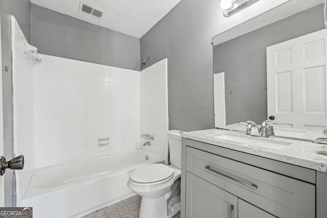 full bathroom with tub / shower combination, tile patterned flooring, vanity, a textured ceiling, and toilet