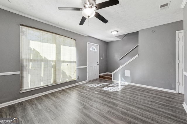 entrance foyer with dark hardwood / wood-style flooring, ceiling fan, and a textured ceiling