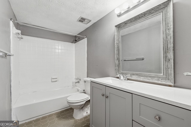 full bathroom featuring vanity, shower / washtub combination, toilet, and a textured ceiling