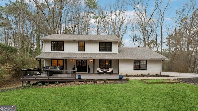 view of front of property with a wooden deck, an outdoor hangout area, and a front yard