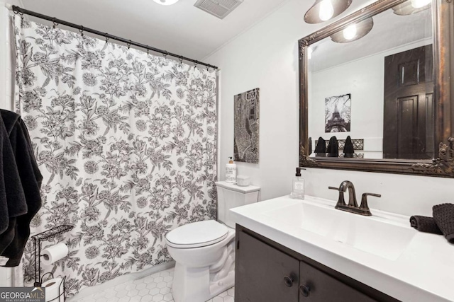 bathroom with vanity, tile patterned floors, and toilet