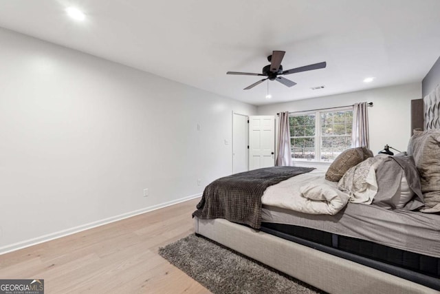 bedroom with ceiling fan and light hardwood / wood-style floors