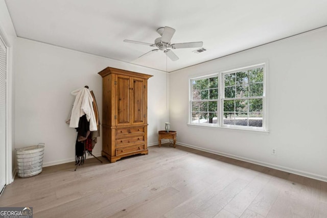 unfurnished bedroom with ceiling fan and light hardwood / wood-style flooring