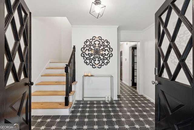 foyer featuring crown molding