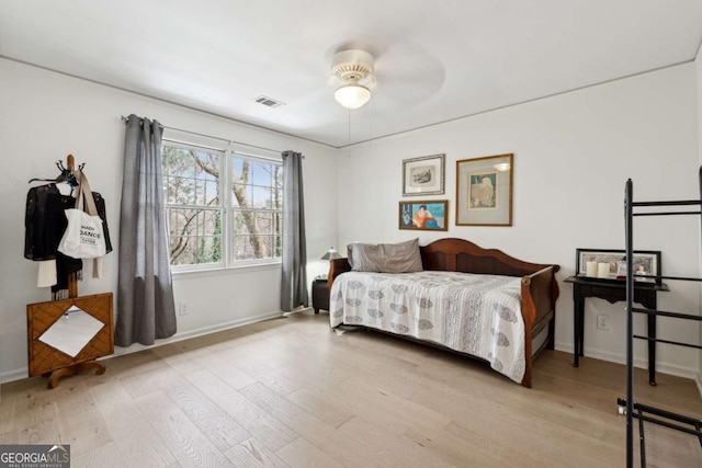 bedroom with ceiling fan and light hardwood / wood-style flooring