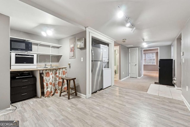 kitchen featuring stainless steel fridge, light hardwood / wood-style flooring, rail lighting, black microwave, and wall oven