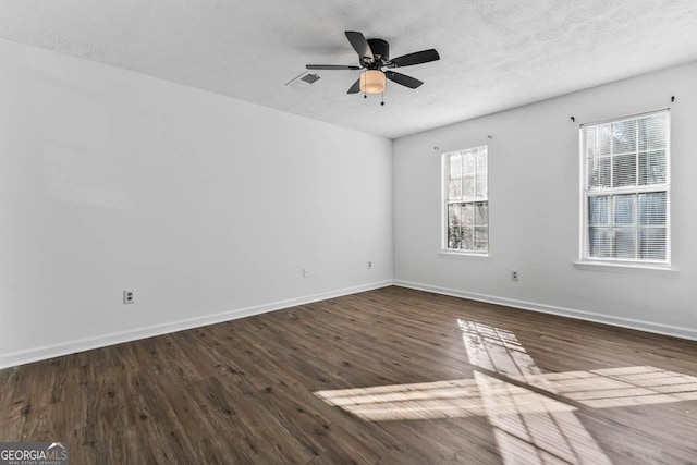 unfurnished room featuring ceiling fan, a textured ceiling, and dark hardwood / wood-style flooring