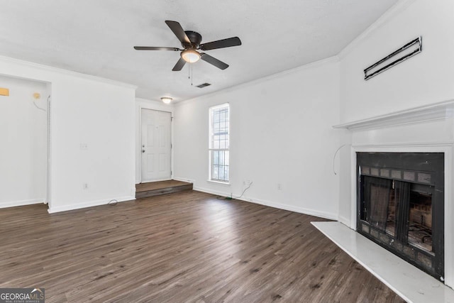 unfurnished living room featuring dark hardwood / wood-style flooring, crown molding, and ceiling fan