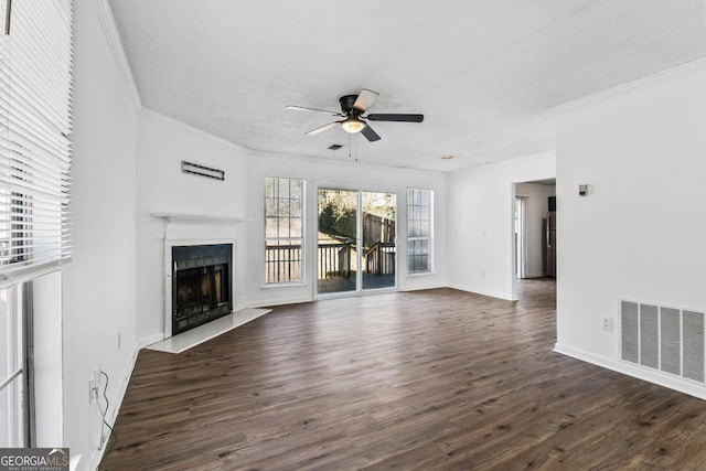 unfurnished living room featuring crown molding, dark hardwood / wood-style floors, a textured ceiling, and ceiling fan