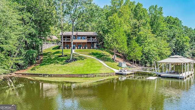 back of house with a gazebo, a water view, and a yard