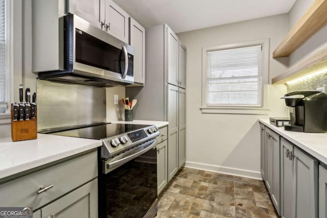 kitchen with stainless steel appliances and gray cabinetry