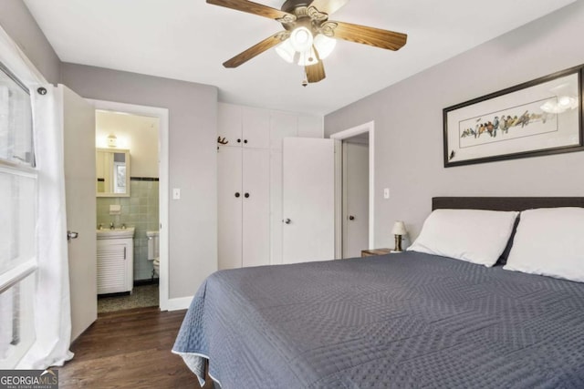 bedroom featuring dark wood-type flooring, ceiling fan, and ensuite bathroom