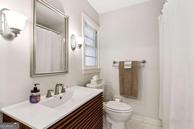 bathroom featuring vanity and toilet