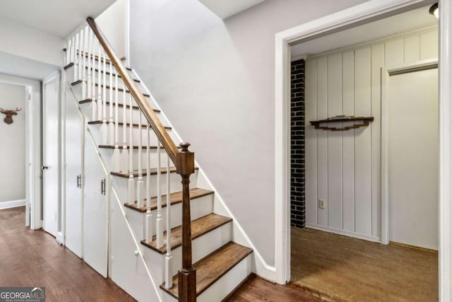 staircase with hardwood / wood-style floors