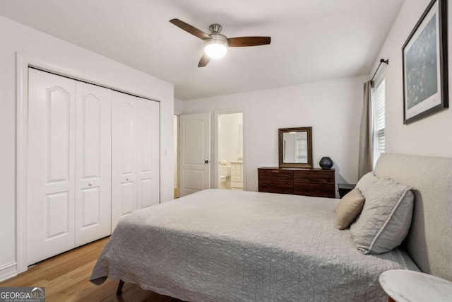 bedroom with ensuite bathroom, a closet, ceiling fan, and light wood-type flooring