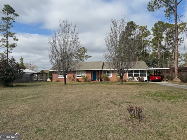 ranch-style home with a front lawn and a carport