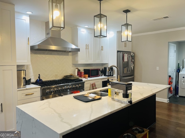 kitchen with pendant lighting, light stone counters, stainless steel appliances, and white cabinetry