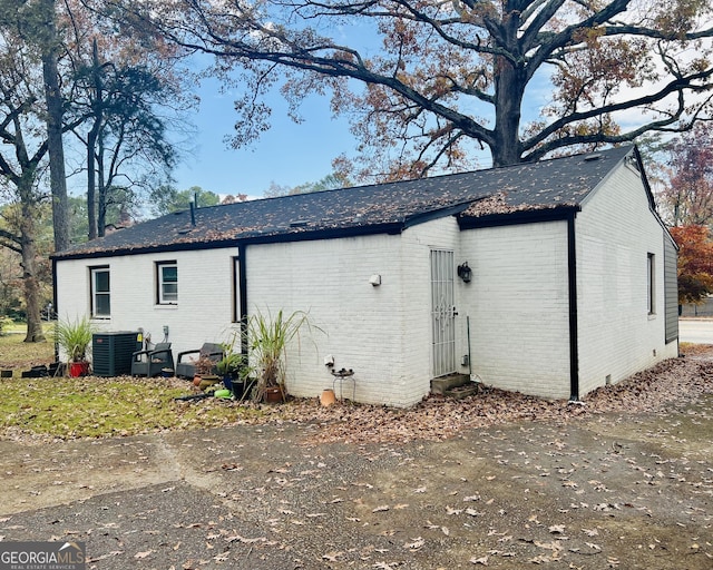 rear view of property with cooling unit