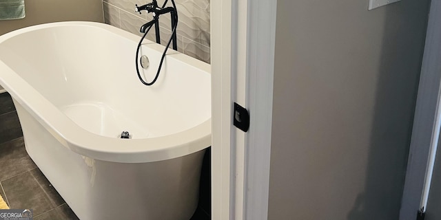 bathroom featuring tile patterned flooring and a bath