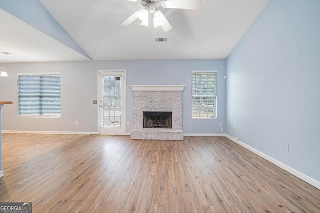 unfurnished living room featuring vaulted ceiling, light hardwood / wood-style floors, and ceiling fan