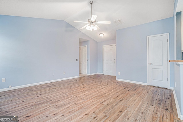 empty room featuring vaulted ceiling, light hardwood / wood-style floors, and ceiling fan