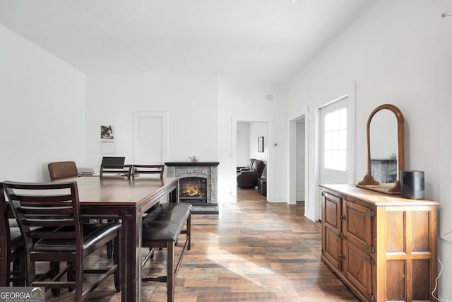 dining room with hardwood / wood-style flooring and a fireplace